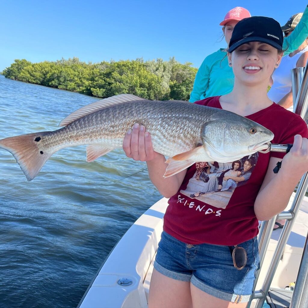 Young Woman with Red Fish Cape Coral Charter Fishing